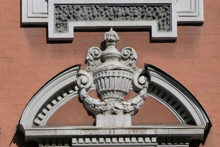 Ancient stucco molding in the form of a vase on the wall.の写真素材