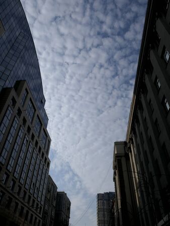 The tops of the buildings seem to be floating in the clouds.の写真素材