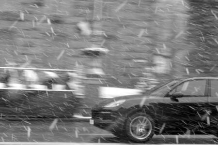 A car that rushes along the road in the snow.の写真素材