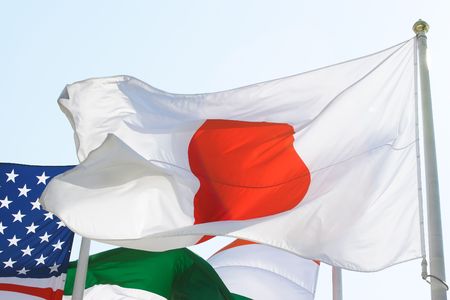 Flags of several countreies against the light skyの写真素材