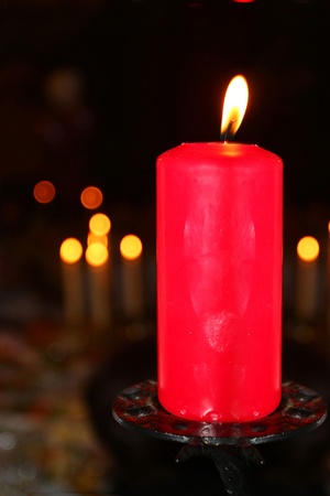 The image of a burning candle under the blurred backgroundの写真素材