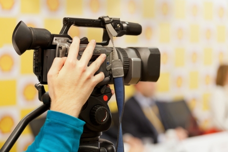 The image of video camera under the tripodの写真素材