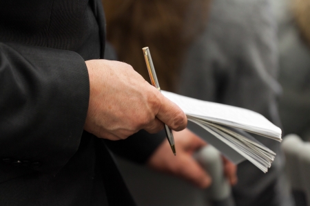 Hand of an elderly businessman and note-book in itの写真素材