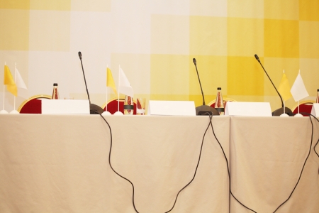 Microphones on a table in a conference hallの写真素材