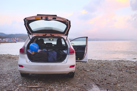Car with open trunk on a sea coastの写真素材