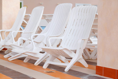 swimming pool and many white empty chaise-longue