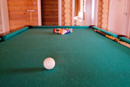 White billiard ball on a green billiard tableのeditorial素材