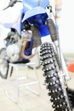 Closeup detail of a motorcycle front wheel with metall spikesの写真素材