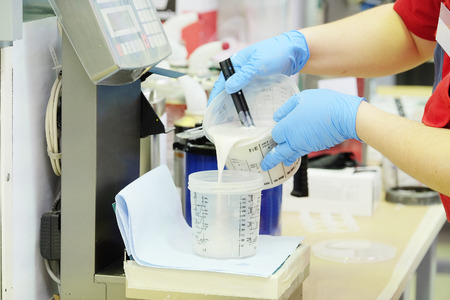 Preparation of paint for car painting in car body shopの写真素材