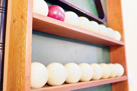 Billiard balls on a wooden shelf
