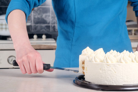 Woman cuts the cake