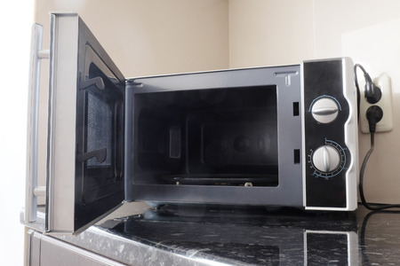 Empty microwave oven with open doorの写真素材
