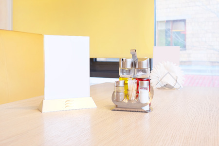 Bottles with olive oil, vinegar, salt and pepper, napkin on the table in restaurantの写真素材