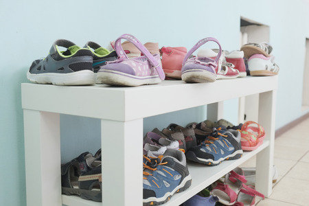 White shoe shelf with children shoesの写真素材