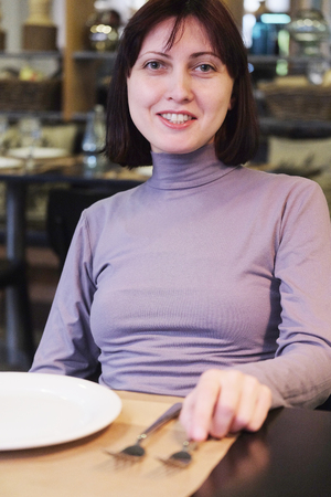 Woman sitting in the restaurantの写真素材