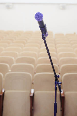 The image of microphone and blurred auditorium in the backgroundの写真素材