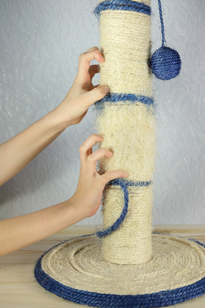 Children hand sharpening his claws on a scratching post like a catのeditorial素材