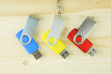 USB flash drive on the wooden background