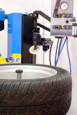 The image of a wheel on a tire machineの写真素材