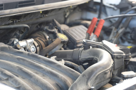 Car with open hood in a repair station