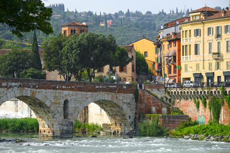 Verona, Italy - June, 16, 2017: embankment of Adige river in Florence, Italy with Ponte Pietra bridgeのeditorial素材