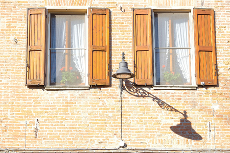 Ferrara, Italy - June, 30, 2017: sun blinds on a windows of an inhabited house in Ferrara, Italyのeditorial素材