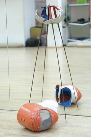 Sport rapiers and helmets close up