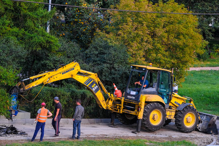 Moscow, Russia - September, 4, 2018: tractor repairs the road in Moscow, Russia
