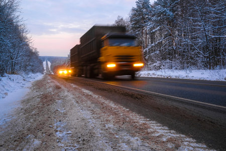 image of a truck on a winter roadの写真素材