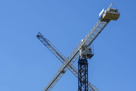 image of a tower crane at the construction site of a residential houseの写真素材