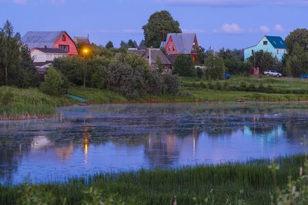 Rural landscape with the image of sunset on Lopasnia river in Moscow region, Russiaの写真素材