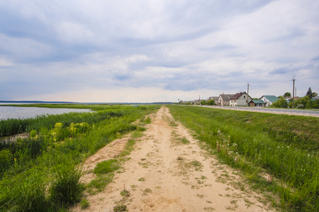 Braslavl, Belarus - May, 26, 2019: image of country road along rural houses and lakes in Braslavl, Belarusのeditorial素材