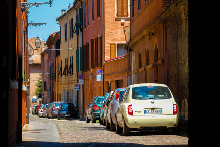 Ferrara, Italy - July, 11, 2019: cars on a parking in a center of Ferrara, Italy