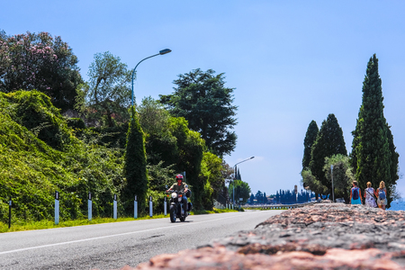 Garda, Italy - July, 26, 2019: landscape with the image of a road in Italy at sunsetのeditorial素材