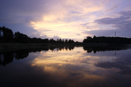 Beautiful sunset over the lake. Beautiful sky reflected in the water.