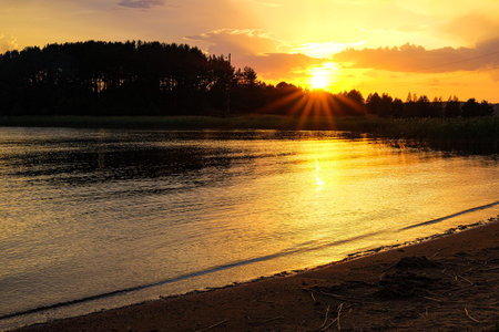Beautiful sunset on the river. The sun sets over the lake.