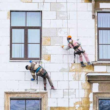 St. Petersburg, Russia - November, 6, 2021: Steeplejacks work on a wall of a house in St. Petersburg, Russiaのeditorial素材