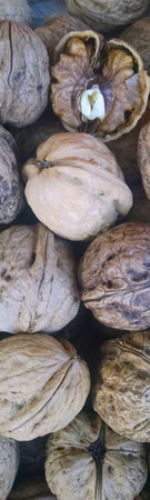 Vertical image of walnuts at a French produce stand