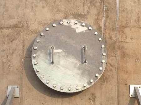 Stainless Manhole On Cement Wallの写真素材