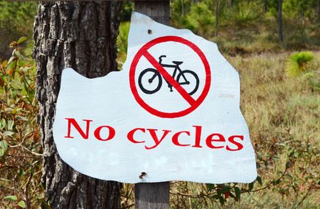 Wooden no cycles sign with nature background at Phu Kradueng National Park, Loei province, Thailandの写真素材