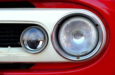 Front view of headlight on red old truckの写真素材