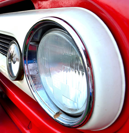Side view of headlight on red old truck