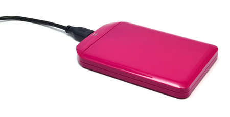 Pink external hard drive for data storage and security - isolated on white backgroundの写真素材