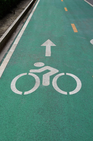 Green bicycle lane on asphalt road - sport and healthy lifestyle conceptの写真素材