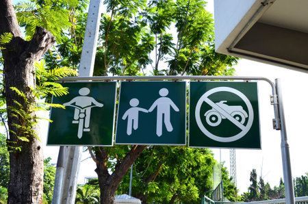 Bicycle and pedestrian shared route sign with no motorcycle on green metal signpostの写真素材