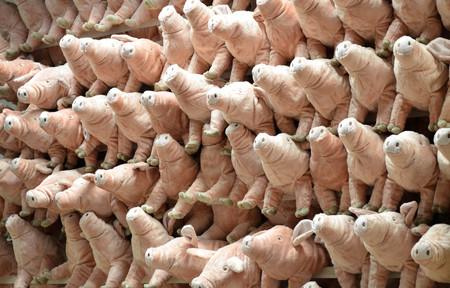 Pink fluffy pig doll hanging on the wallの写真素材