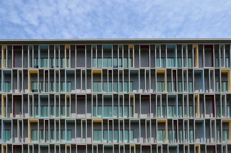 Colorful paint at facade of modern office building against hazy blue skyの写真素材