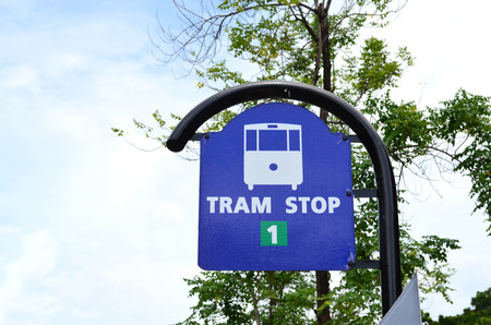 Road sign - white tram stop sign  on blue boardの写真素材