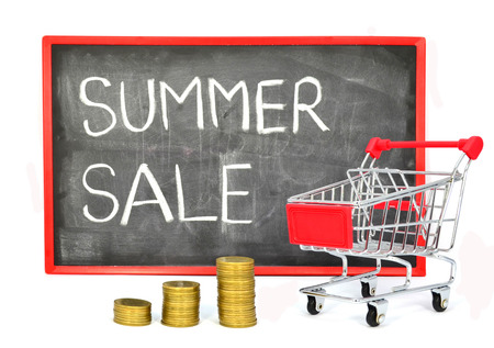Shopping cart with chalk written word "Summer Sale"  - on black board isolated on white backgroundの写真素材