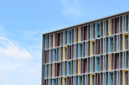 Colorful paint at facade of modern office building against hazy blue sky